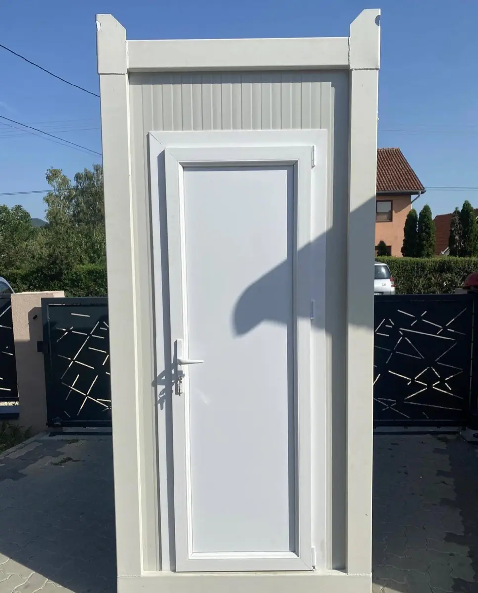 Photo: A white cabin with a real-feel toilet